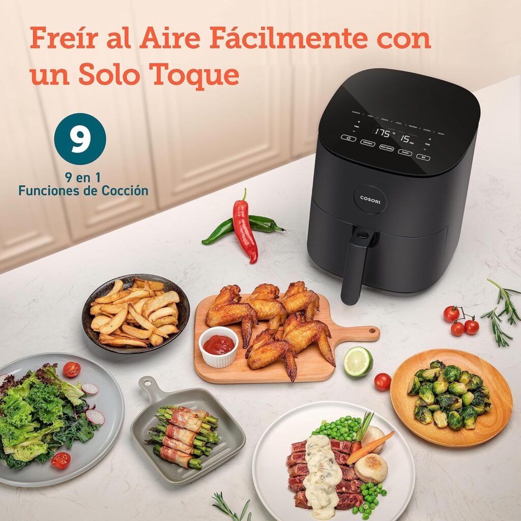 Freidora COSORI Pro LE L501 en cocina con platos variados alrededor: papas fritas, ensalada, espárragos envueltos y alitas de pollo cocinadas sin aceite
