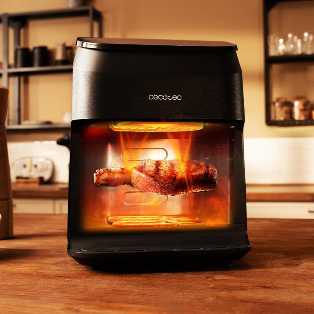 Freidora Cecotec Smokin'Heat 4000 cocinando con efecto visual de calor envolvente y resistencia superior e inferior activas
